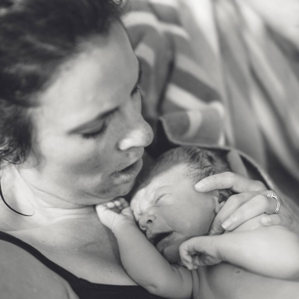 A mother and her newborn baby in a birthpool