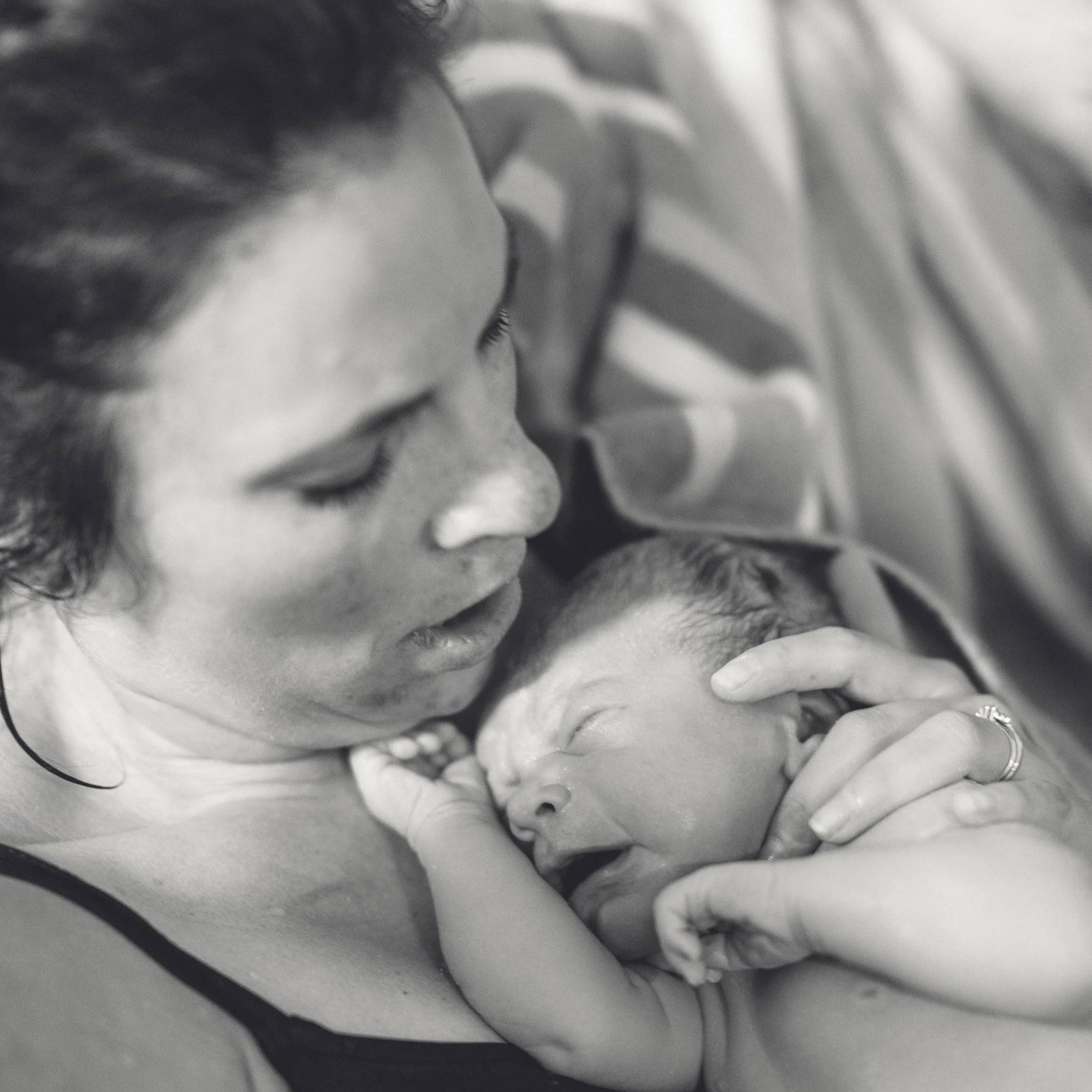 A mother and her newborn baby in a birthpool
